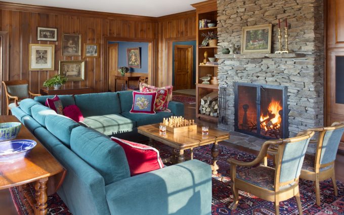 The living room of this newly constructed Vermont farmhouse by Boston Interior Designer Elizabeth Swartz Interiors combines contemporary design elements with traditional architectural details, rich colors and local materials.