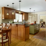 The kitchen of this Boston-area home features a modern interior with traditional colonial architecture and custom cabinetry. Traditional Colonial Interior Design by Elizabeth Swartz Interiors.