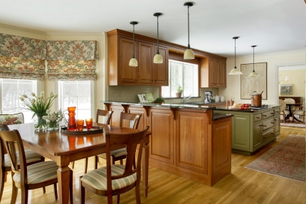 The kitchen of this Boston-area home features a modern interior with traditional colonial architecture and custom cabinetry. Traditional Colonial Interior Design by Elizabeth Swartz Interiors.