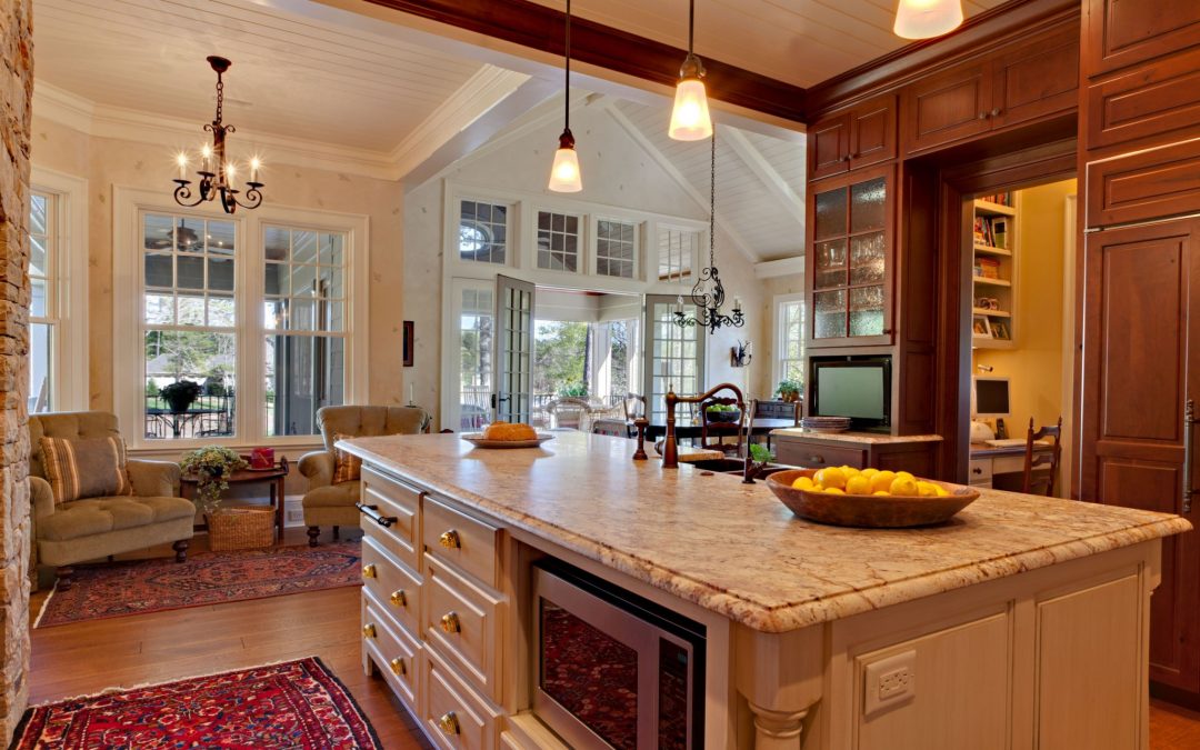 Looking from the kitchen through the dining room and out to a main floor screened porch you can see the vaulted ceilings and large windows in each room designed by Boston Interior Designer Elizabeth Swartz Interiors.