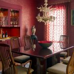 The contemporary interior design of this dining room blends rich colors, custom cabinetry, warm woods, glass and modern fabrics.