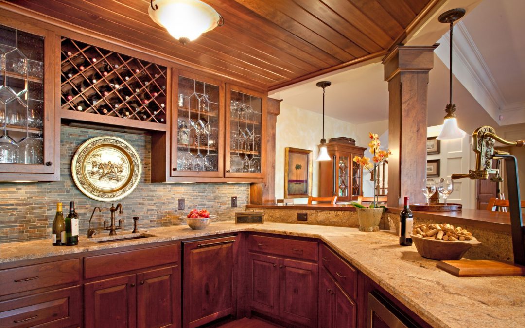 The kitchen in the entertaining area on the lower level of this lake house vacation home was designed by Boston interior designer Elizabeth Swartz Interiors.