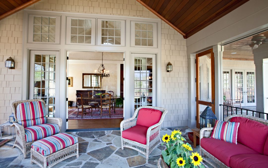 An screened porch on the main level designed by Boston interior designer Elizabeth Swartz Interiors offers a place to gather for conversation or entertaining.