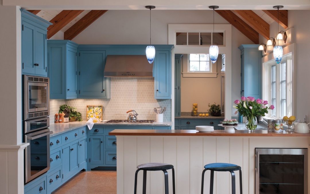 The interior design of the kitchen in this beach cottage on Martha's Vineyard by Boston Interior Designer Elizabeth Swartz Interiors features cool blues  and warm woods reflecting the home's island roots.