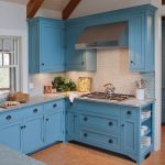 The interior design of the kitchen in this beach cottage on Martha's Vineyard by Boston Interior Designer Elizabeth Swartz Interiors features cool blues and warm woods reflecting the home's island roots.