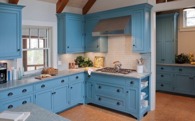The interior design of the kitchen in this beach cottage on Martha's Vineyard by Boston Interior Designer Elizabeth Swartz Interiors features cool blues and warm woods reflecting the home's island roots.