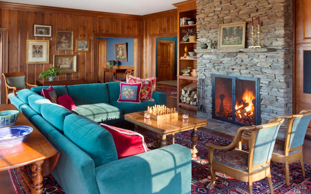 The living room of this newly constructed Vermont farmhouse by Boston Interior Designer Elizabeth Swartz Interiors combines contemporary design elements with traditional architectural details, rich colors and local materials. 