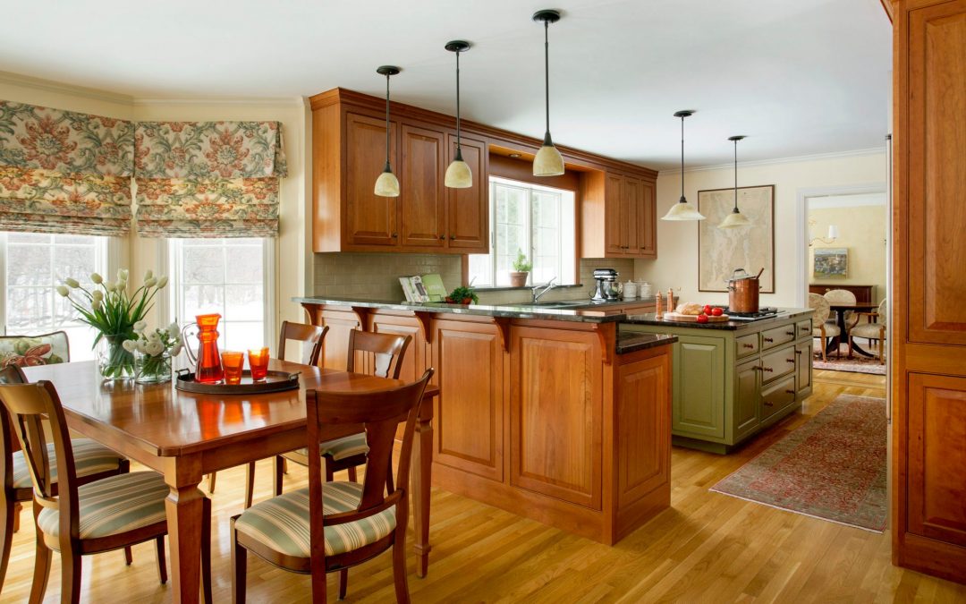 The kitchen of this Boston-area home features a modern interior with traditional colonial architecture and custom cabinetry. Traditional Colonial Interior Design by Elizabeth Swartz Interiors.