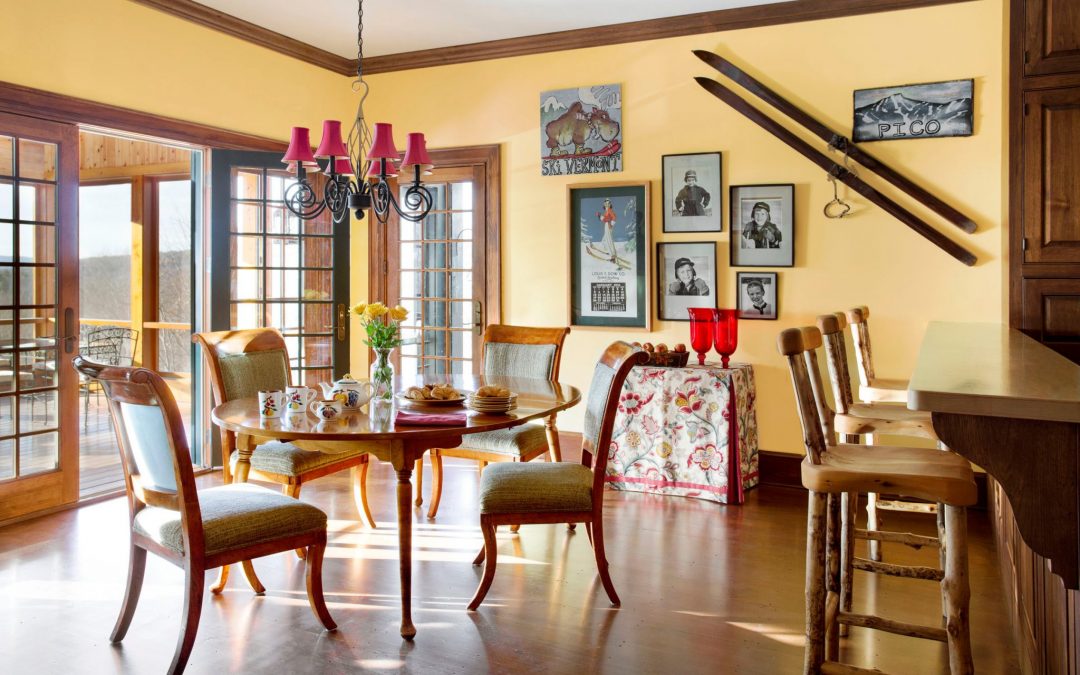 The casual eat in dining area off of the kitchen of this newly constructed Vermont farmhouse by Boston Interior Designer Elizabeth Swartz Interiors combines contemporary design elements with traditional architectural details, rich colors and local materials. 