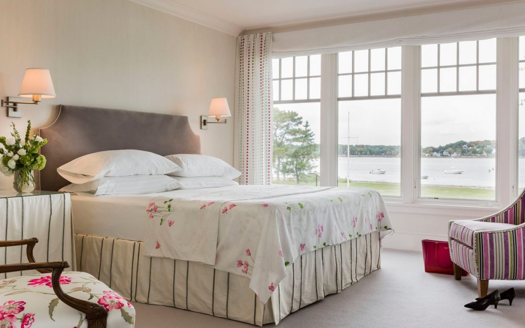 The guest bedroom of this contemporary coast home designed by Boston Interior Designer Elizabeth Swartz Interiors uses color in a smart way to create a tranquil and relaxing space that focuses on the view.