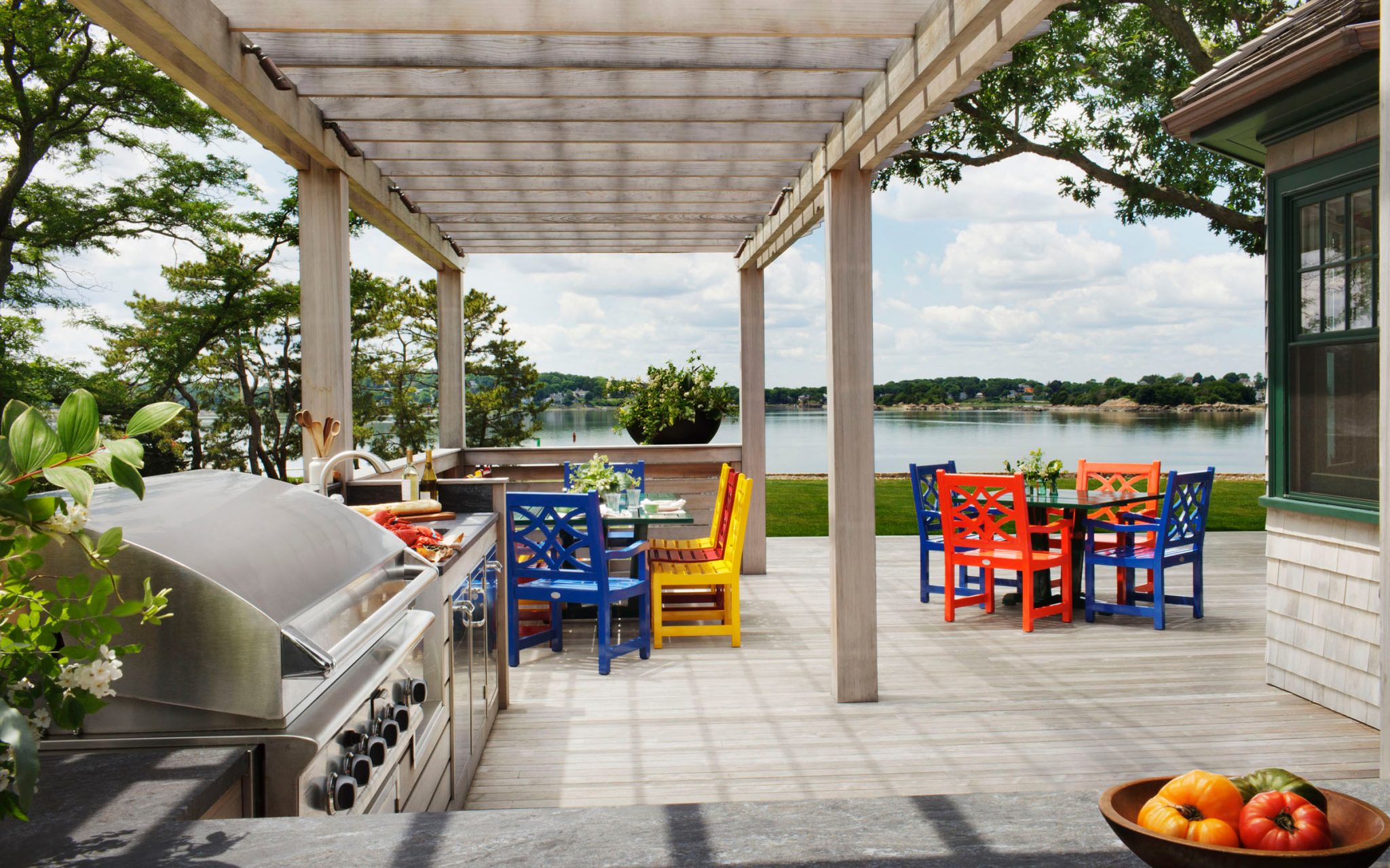 The exterior spaces of this contemporary coastal home by Boston Interior Designer Elizabeth Swartz Interiors reflects the bright and whimsical aesthetic used within the home.