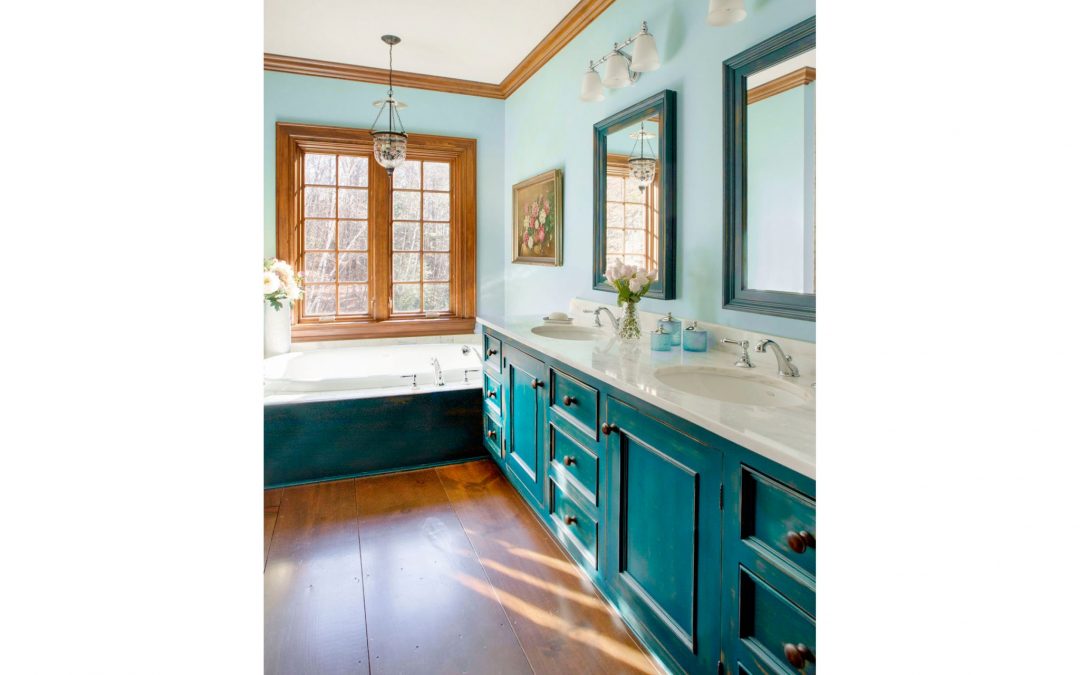 The master bathroom of this Vermont farmhouse by Boston Interior Designer Elizabeth Swartz Interiors combines contemporary design elements with traditional architectural details, custom cabinetry, rich colors and local materials. 