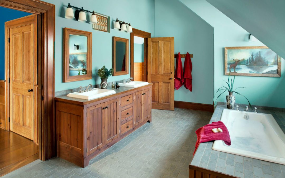 A bathroom in this newly constructed Vermont farmhouse by Boston Interior Designer Elizabeth Swartz Interiors combines contemporary design elements with traditional architectural details, custom cabinetry and local materials. 