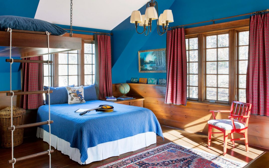 An additional bedroom in this Vermont family farmhouse by Boston Interior Designer Elizabeth Swartz Interiors combines contemporary design elements with traditional architectural details, rich colors and local materials.