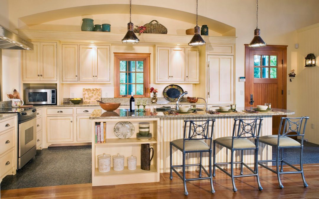 The guest house kitchen of this white mountain retreat features custom cabinetry and interior design by Boston Interior Designer Elizabeth Swartz Interiors.