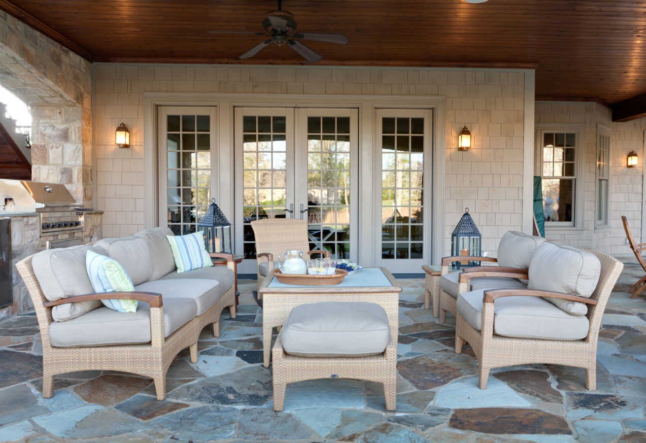 The colors of the custom-designed stone patio provided the inspiration for the soft blue-grey upholstery on this contemporary outdoor furniture designed by Boston interior designer Elizabeth Swartz Interiors.