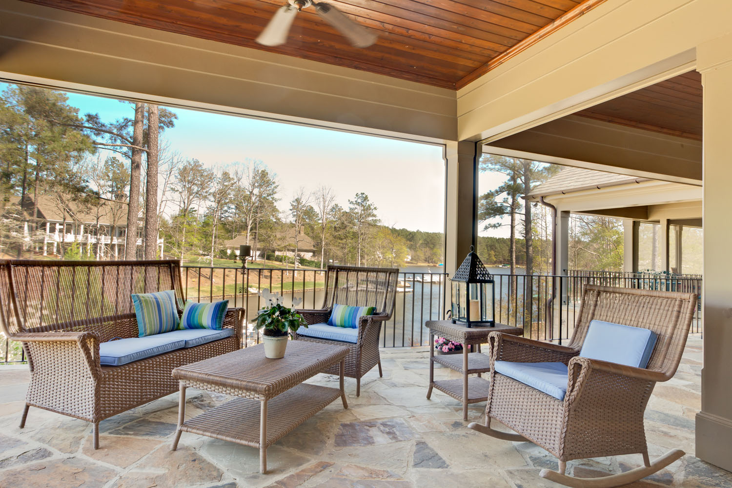 In this porch off a master suite makes living outdoors easy with retractable screens that can be put in place to protect the couple from insects, or on bugless days be opened to allow unobstructed views.