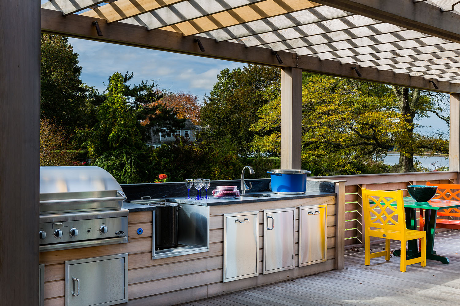 Living outdoors i easy in this space designed by Boston interior designer Elizabeth Swartz Interiors includes a complete kitchen .