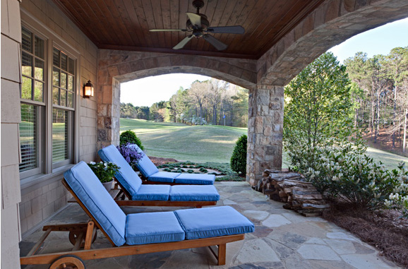 Bold blue hues from the interior were carried through on upholstered outdoor patio furniture in Elizabeth Swartz Interiors' lakeside project.